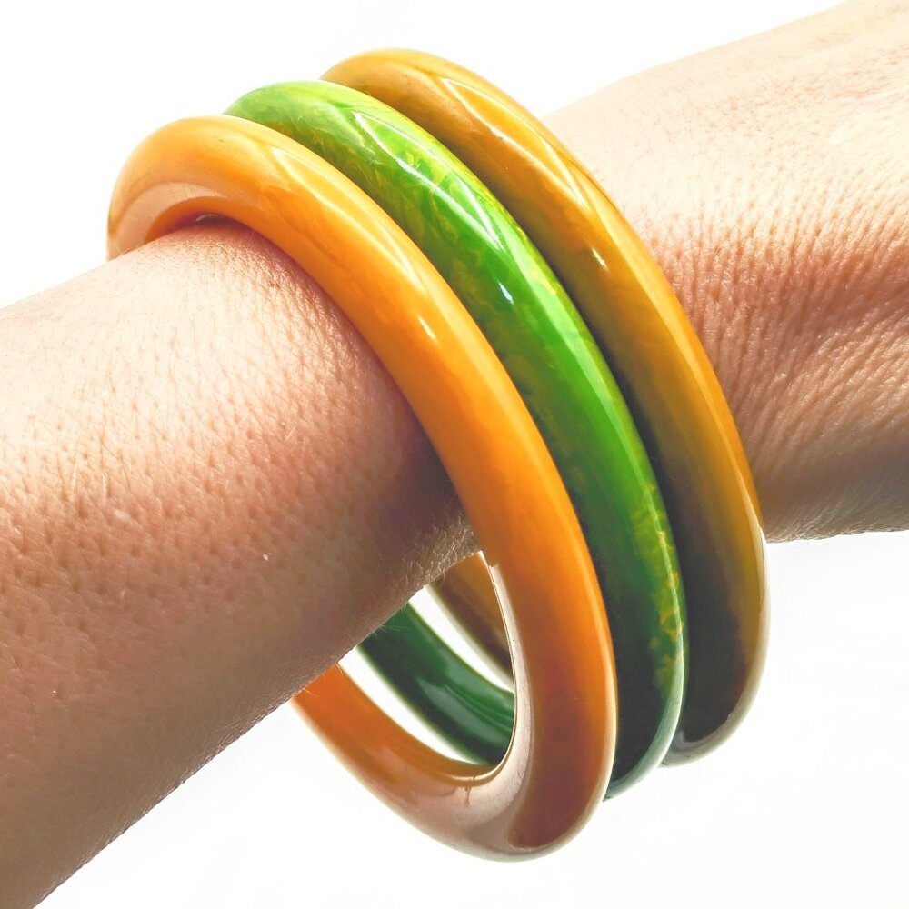 Three bakelite bangle bracelets in pea green, yellow and mustard 1960s